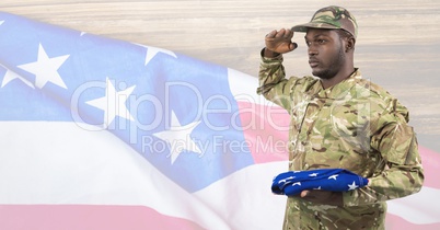 Side view of soldier holding an american flag in front of american background