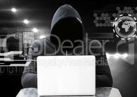 Hacker using a laptop in front of dark background with digital icons