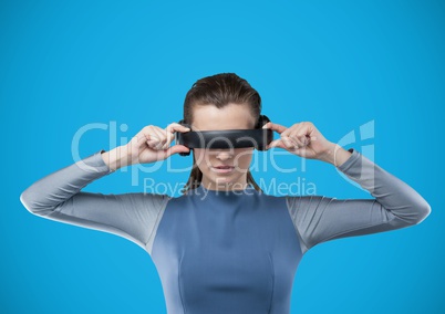 Woman in virtual reality headset against blue background