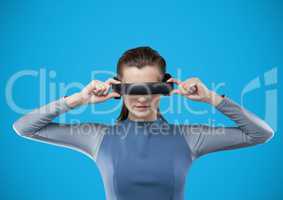 Woman in virtual reality headset against blue background