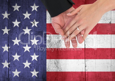 Couple with hands together  against american flag