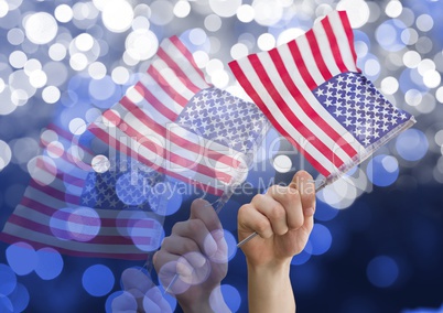 Hands holding american flags against shiny background