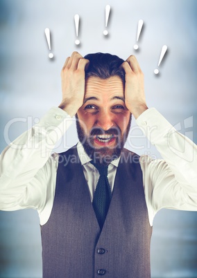 Frustrated business man against blurry blue wood panel and 3D exclamation points