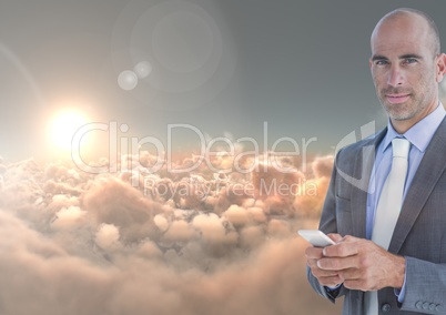 Smiling man texting in 3D cloudy background