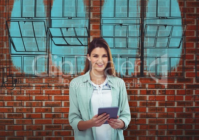 young businesswoman smiling with tablet in front a brick wall with the  blueprint of new building on