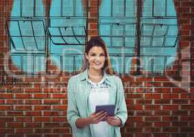 young businesswoman smiling with tablet in front a brick wall with the  blueprint of new building on