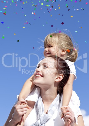 Confetti against daughter on mother's shoulders