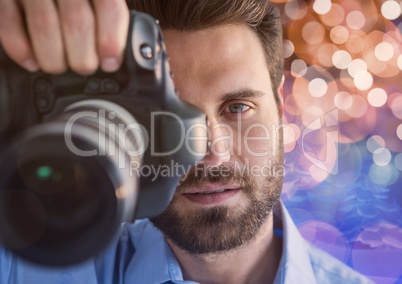 3d photographer foreground taking a photo with reflex. Blurred  brown and blue lights background and