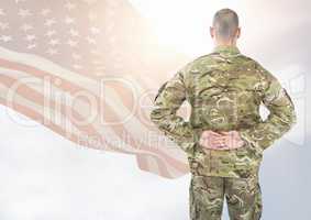 Back view of soldier in front of white background with american flag