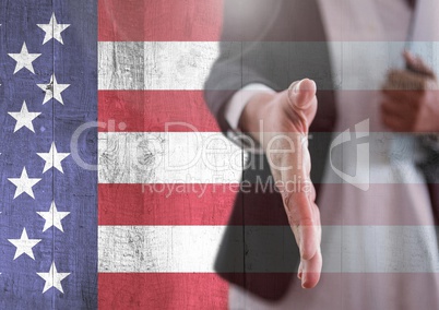 Part of a man offering his hand against american flag