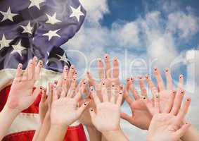 Hands up against fluttering american flag