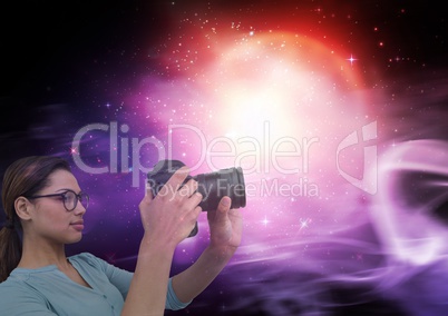 Photographer taking pictures against galaxy background