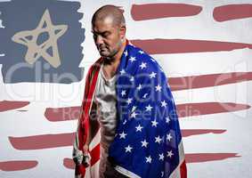 Man wrapped in american flag against hand drawn american flag and white wall