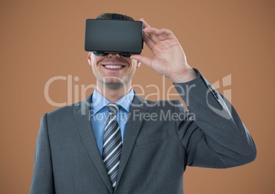 Man in virtual reality headset against brown background
