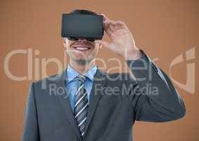 Man in virtual reality headset against brown background