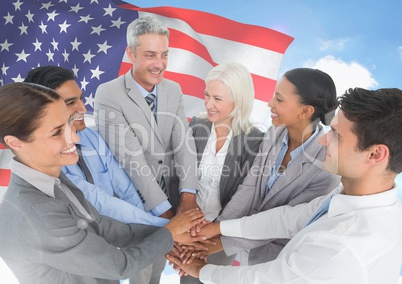 Business people with hands together against american flag