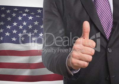 Business man with thumb up against american flag