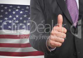 Business man with thumb up against american flag