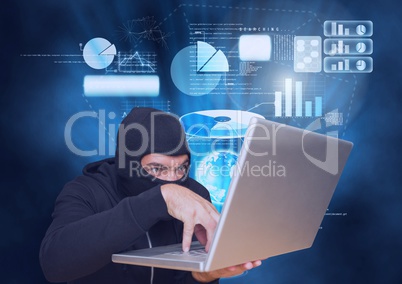 Hacker with hood  working on a laptop in front of blue digital background