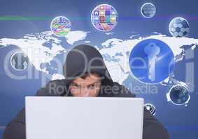 Hacker using a laptop in front of digital background with graphics ans mapworld