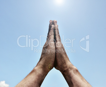 Two male hands folded in prayer gesture