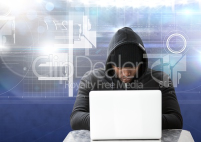 Hacker using a laptop in front of blue digital background