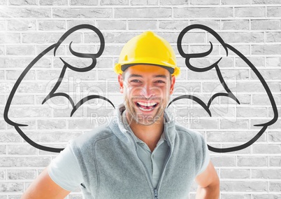 happy worker with hat in front of fists draw on the bricks wall
