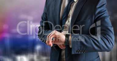 Business man mid section looking at watch against blurry purple wall with city doodle