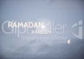 White ramadan text against evening sky and moon