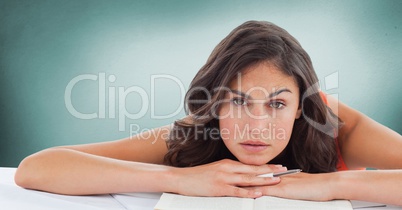 College student at desk against green background