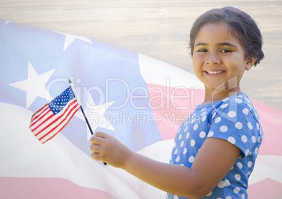 Little girl holding american flag against american flag