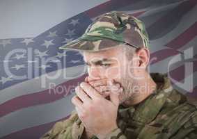 Soldier hiding his mouth with his hands in front of american flag