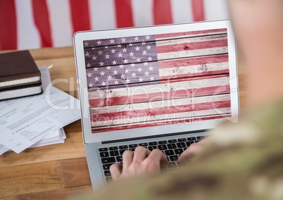 Business man working on his laptop with the american flag