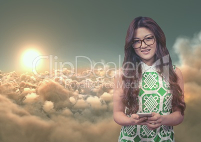 Smiling woman texting against 3D cloudy sky with sun background