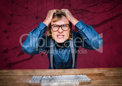 Frustrated business man at desk against maroon background and arrow graphics