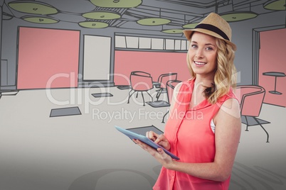 Smiling blond woman using a digital tablet with a colored drawing on background