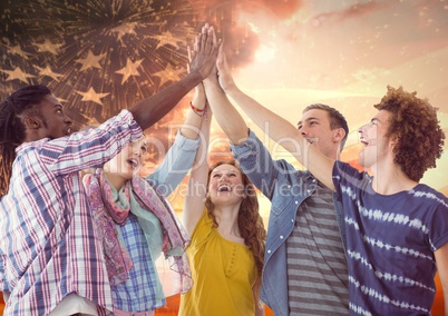 Friends high fiving against american flag