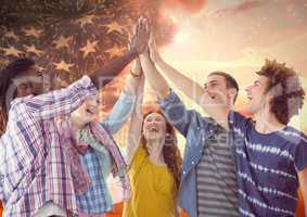 Friends high fiving against american flag