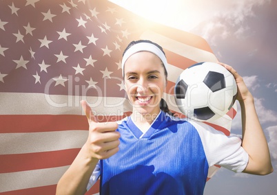 Thumb up woman football player against fluttering american flag