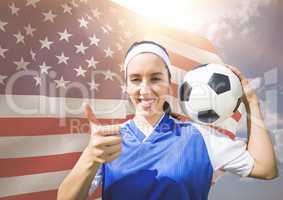 Thumb up woman football player against fluttering american flag