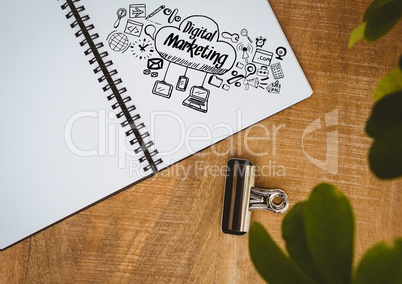 Digital marketing doodle on notepad next to plant