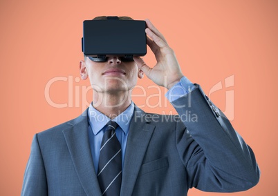 Man in virtual reality headset against orange background