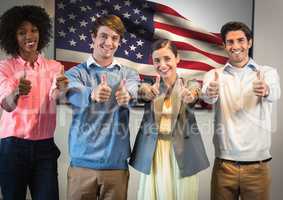 Colleagues with thumbs up against american flag