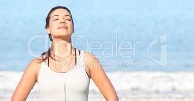 Woman soaking up sun against blurry water