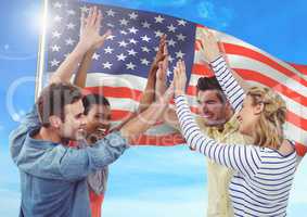 Smiling friends throwing up their hands against fluttering american flag background