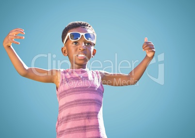 Boy in sunglasses hands out against blue background
