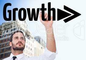 Businessman in front of a building, writing grow + arrow on the screen