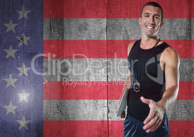 Sports coach shaking his hand against american flag