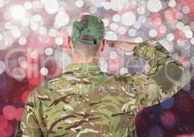 Military saluting against glowing background
