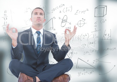 Business man meditating in blurry grey office with flare and math doodle
